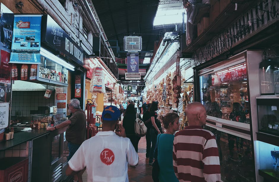 People Shopping At Stores In An Alley